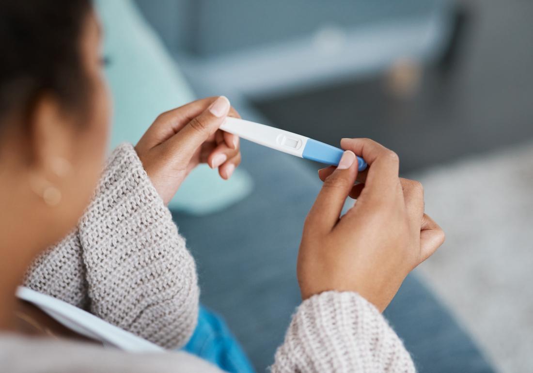 Woman checking pregnancy test 