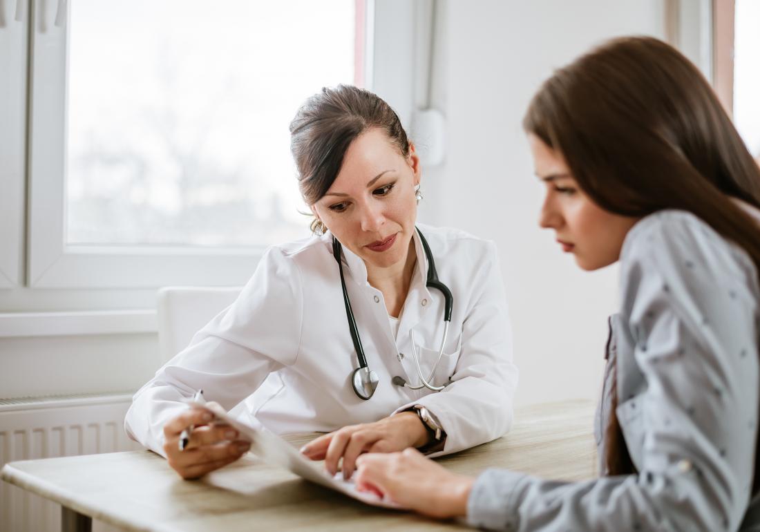 Female doctor talking to patient