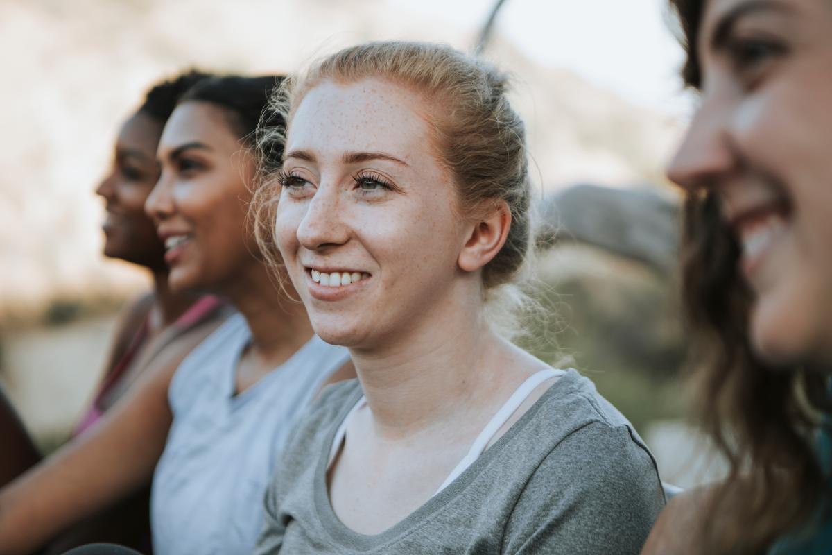 Young women listening and smiling