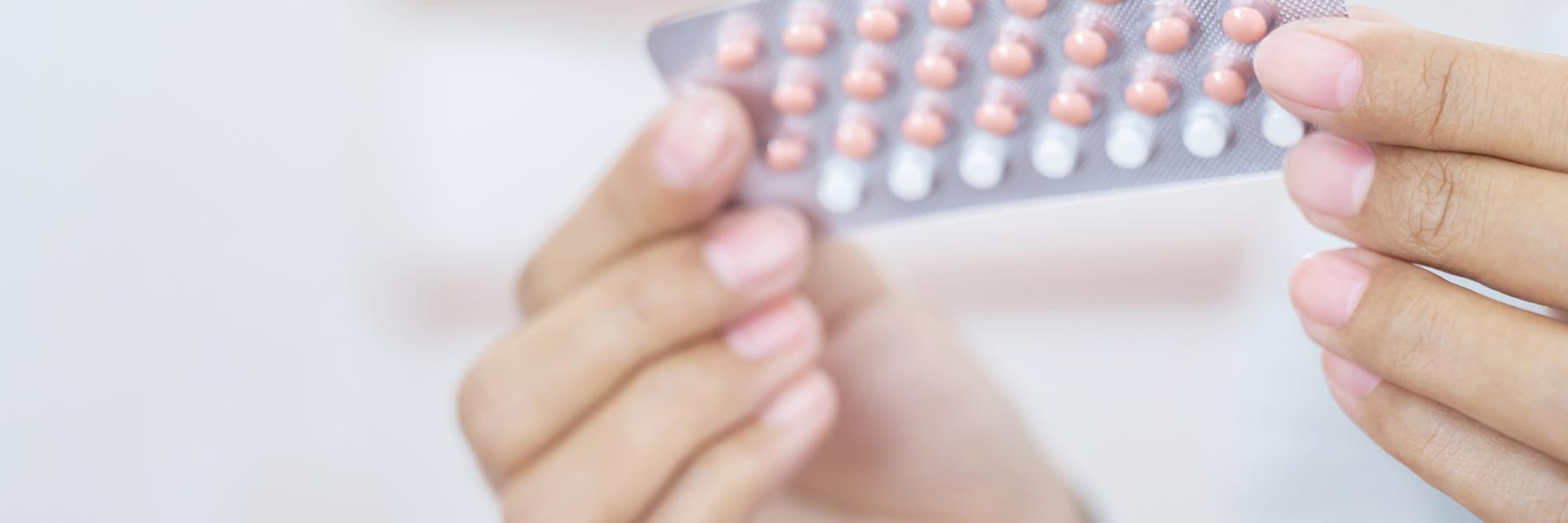 Girl holding combined oral contraceptive pill