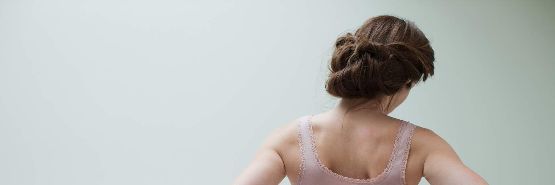 Woman holding bottom of back due to endo symptoms