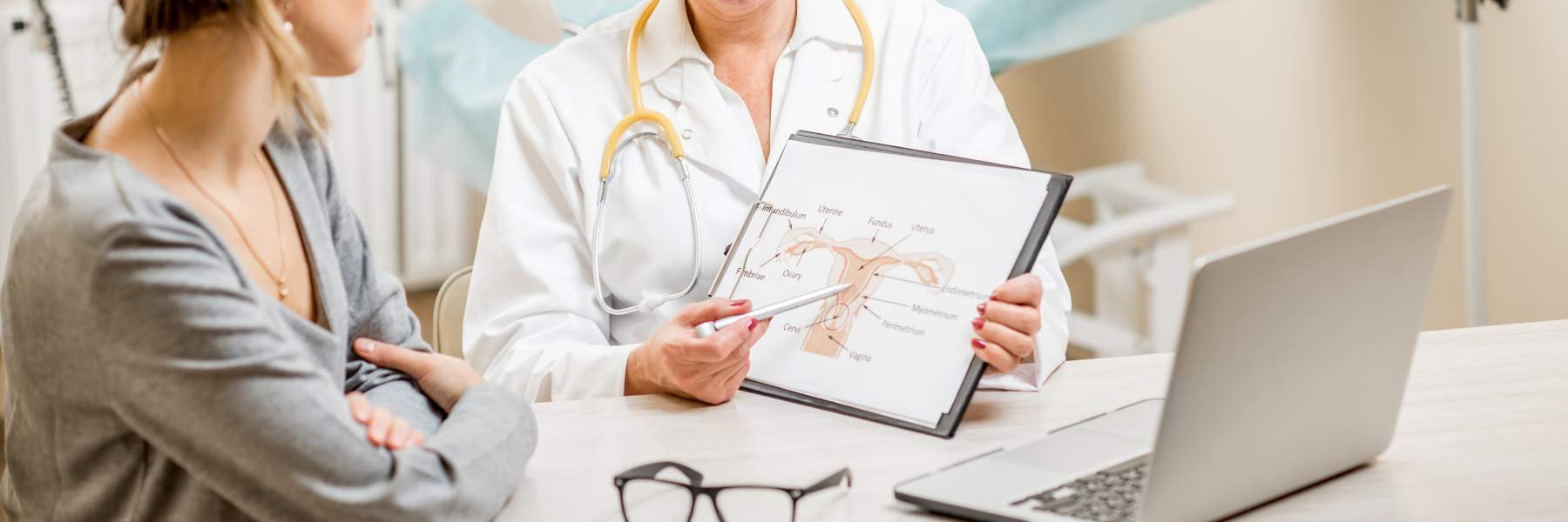 Doctor showing patient image of pelvic area