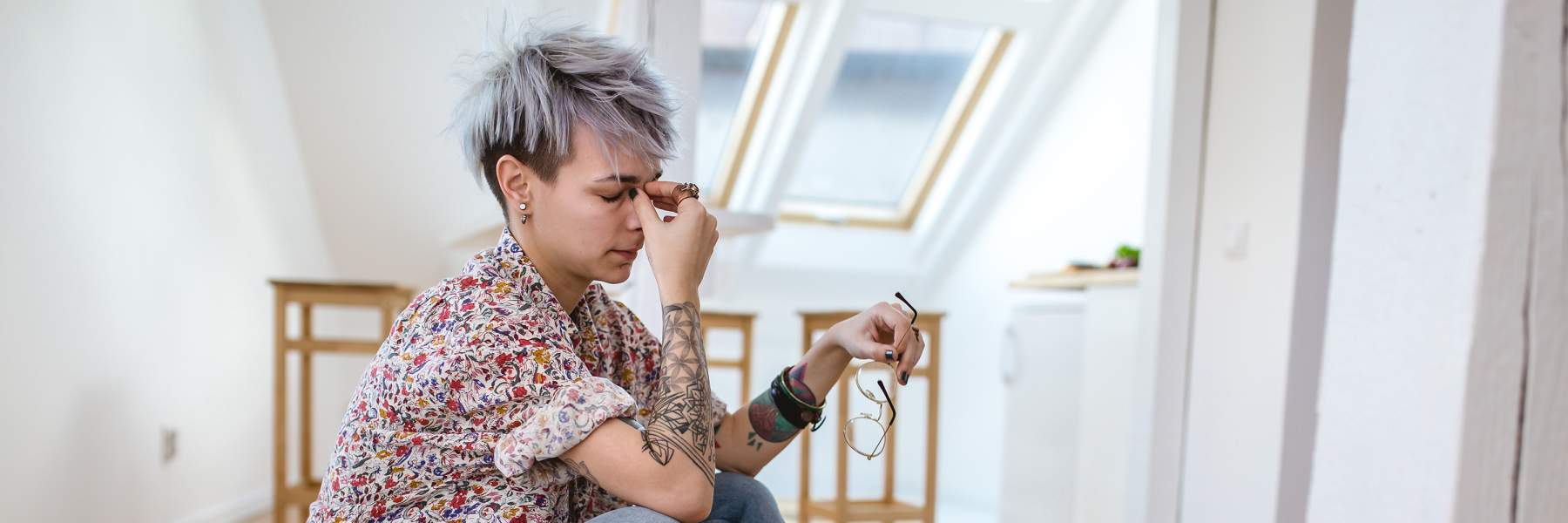 Woman sat on bed next to medication