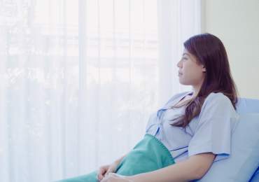 Give sat in hospital bed recovering from bowel surgery