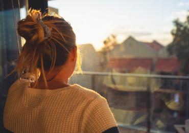 Woman looking out over balcony