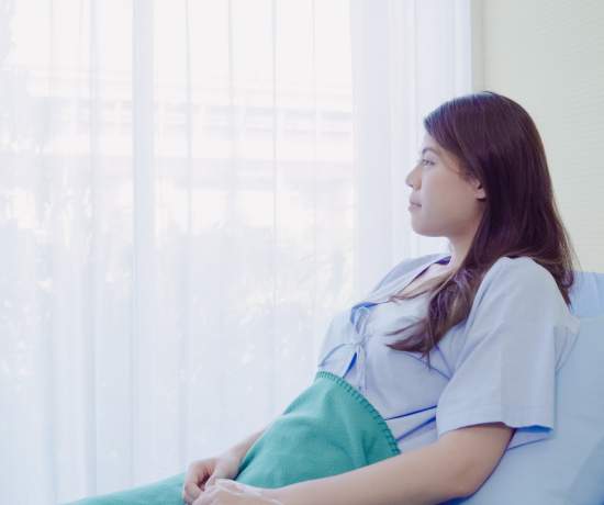 Give sat in hospital bed recovering from bowel surgery