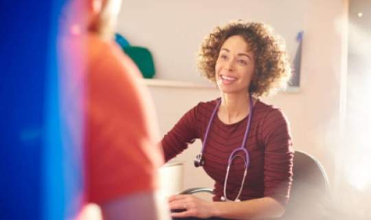 Clinician talking with patient
