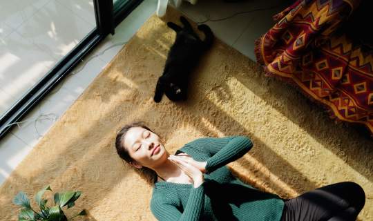Woman meditating laying on floor