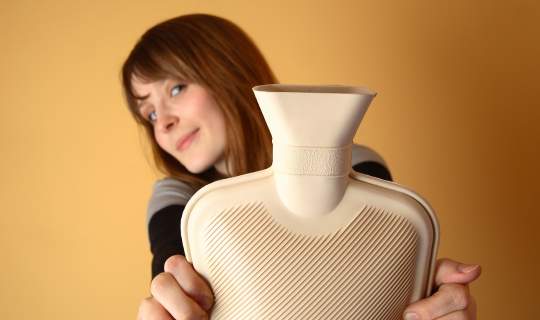 Woman holding water bottle to treat endometriosis