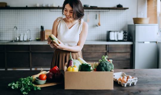 Woman looking at shopping preparing food for a healthy endo diet