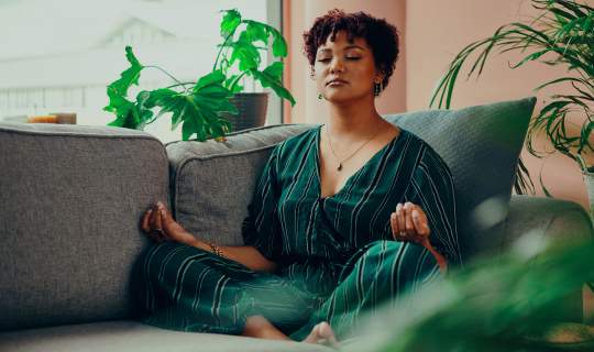 Woman mediating to help reduce endo symptoms