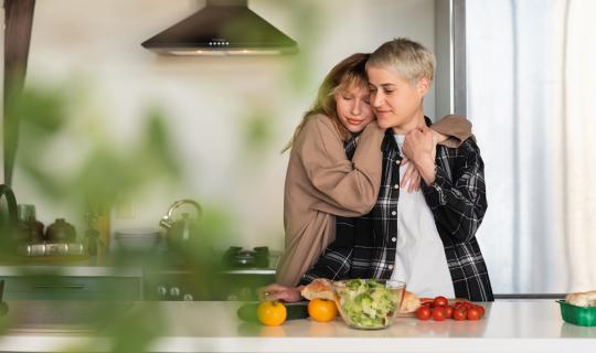 Couple cooking healthy salad food in kitchen