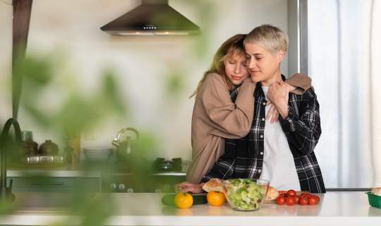 Couple cooking healthy salad food in kitchen